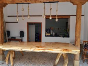 a wooden table in a room with a dining room at Hotel El Giro in Villa de Leyva