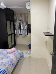 a room with a bed and a room with a window at SunShine HomeStay in Bukit Mertajam