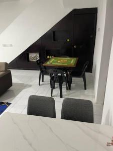 a ping pong table in a room with chairs at SunShine HomeStay in Bukit Mertajam