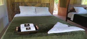 a bedroom with two beds with towels on it at Canoa Inn Natural Lodge in Iquitos