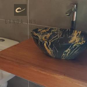 イキトスにあるCanoa Inn Natural Lodgeの洗面台の上にボウルが付いたバスルームカウンター