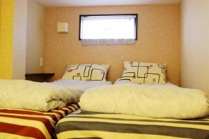 Posteľ alebo postele v izbe v ubytovaní 名古屋 Sakuraya 全屋抗菌涂层预防处理 6分钟直达名古屋车站 2间独立卫生间 2间独立淋浴房 4间卧室