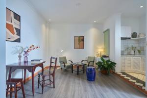 a living room with a dining room table and chairs at M Village Living Cách Mạng Tháng 8 in Ho Chi Minh City
