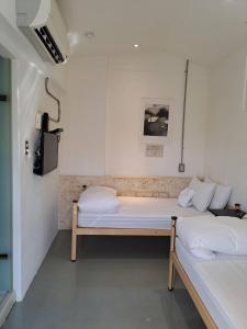 a small room with two beds and a television at King Wow Inn in Tainan