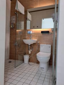a bathroom with a toilet and a sink at King Wow Inn in Tainan