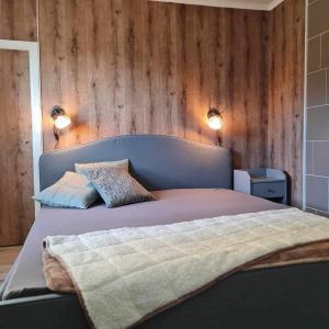 a bedroom with a bed with two lights on the wall at Liebevoll renoviertes Ferienhaus im schwedischen Lappland 