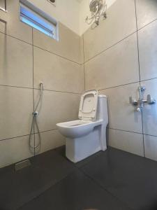 a bathroom with a toilet and a shower at Royal residency in Tindummal