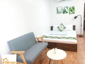 a room with a bed and a couch and a table at Sao Mai Hotel - 35 Cổ Linh- by Bay Luxury 