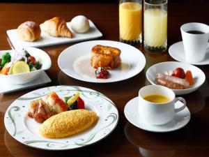 a table with plates of food and a cup of coffee at Kyoto Brighton Hotel in Kyoto