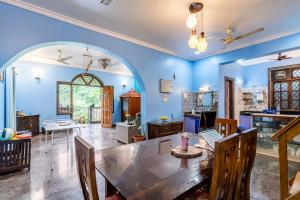 a dining room with a table in a room at Last Minute Trip Hostel Morjim-By The Sea in Morjim