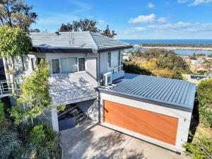 an aerial view of a house with an orange garage at Arrawong in Merimbula