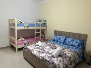 sypialnia z łóżkiem i łóżkiem piętrowym w obiekcie Home Anxhelo w Durrës