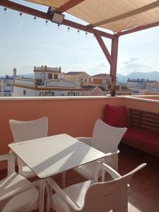 a table and chairs on a balcony with a view at Casa Calypso San Juan de los Terreros in San Juan de los Terreros