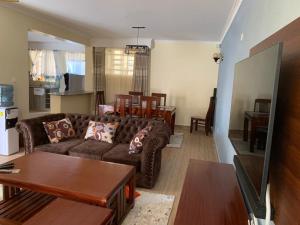 a living room with a couch and a table at 3 bedroom maisonette in Kitengela, Nairobi in Kitengela 