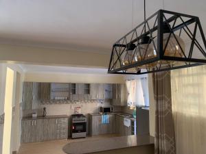 a kitchen with a black light hanging from the ceiling at 3 bedroom maisonette in Kitengela, Nairobi in Kitengela 