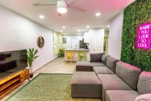 a living room with a couch and a green wall at Cocoanut neighborhood, king bed in Sarasota