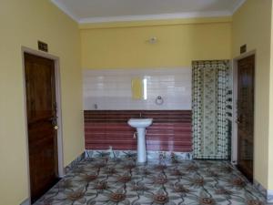 a bathroom with a sink and a toilet in it at TITILI PLAZA in Puri +18 photos