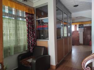 a waiting room with a chair and a window at Hotel Tawang Holiday in Tawang