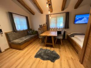 a living room with a couch and a table at Chalet Bergliebe in Bad Hofgastein