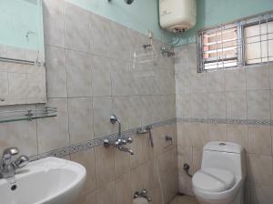 a bathroom with a toilet and a sink at Hotel Tawang Holiday in Tawang +31 photos