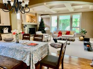 a living room with a table and a christmas tree at share place to stay in Langley