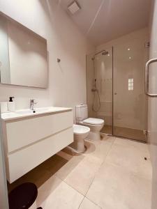 a bathroom with a toilet and a sink and a shower at Mercado Central Apartments in Valencia