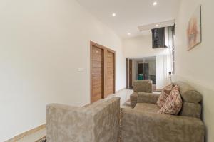 a living room with two chairs and a couch at Hotel Valley Wood Inn in Rājpur