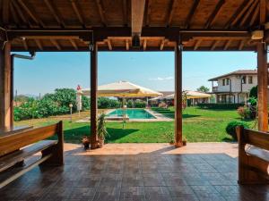 an open patio with a pool and an umbrella at Bendida Village in Pavel Banya