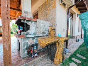 a wooden bench sitting in front of a stone fireplace at Bendida Village in Pavel Banya