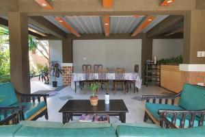 a living room with a table and chairs at 2 Houses w/ parking for best guest in Iloilo City