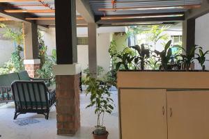 a lobby with chairs and plants in a building at 2 Houses w/ parking for best guest in Iloilo City