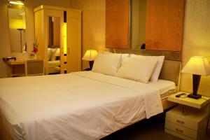 a large white bed in a hotel room at Hotel Ornate in Dhaka