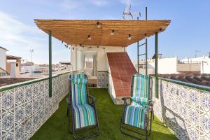 a group of chairs sitting on a roof at Soleada Casa en Nerja in Nerja