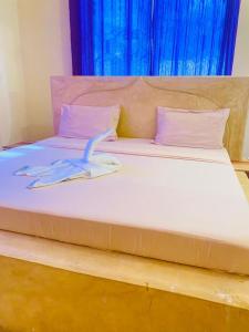 Postel nebo postele na pokoji v ubytování Nakupenda House