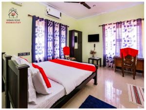 a bedroom with a bed and a tv and curtains at Urban Rose Homestay in Kannur