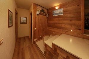 a kitchen with wooden walls and wooden flooring in a house at Eydappartamenti in Sauze dʼOulx