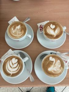 three cups of coffee sitting on a table at Piccolo Hotel Villa Rosa in Ostuni