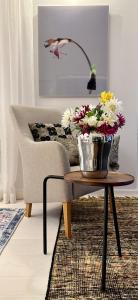 um vaso de flores numa mesa numa sala de estar em Luxury City Seafront Apartment with Balcony em Helsinque