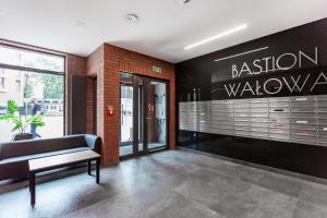 a lobby of a building with a bench and a sign at AVRA Residence II Stare Miasto in Gdańsk