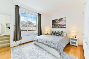 a bedroom with a bed and a large window at Knightsbridge Stylish Two Bedroom Apartment in London