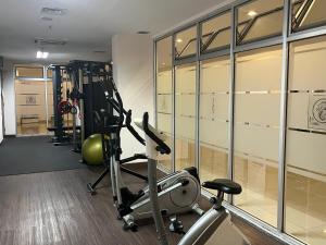 a fitness room with a gym with a treadmill at Cozy 2 BR Sudirman Suites Apartment in Bandung