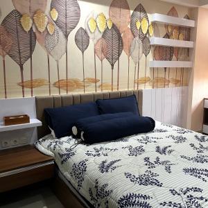 a bedroom with a bed with a mural of butterflies at Cozy 2 BR Sudirman Suites Apartment in Bandung