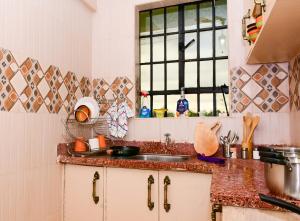 a kitchen with a sink and a window at The Lotus Stay-in at Paradise Apartments, Embu in Embu