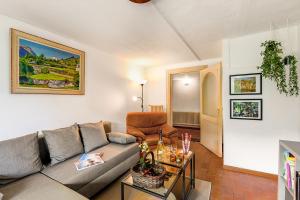 a living room with a couch and a table at Villa Matilde Lake Front - Happy Rentals in Morcote