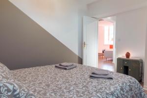 a bedroom with a bed with two towels on it at Suite Germain - 4 pers. in Charleville-Mézières