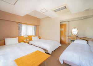 Postel nebo postele na pokoji v ubytování Saka no Hotel Tretio Ochanomizu