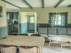 a living room with a couch and a table at Sudersand Resort in Fårö