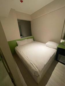 Voodi või voodid majutusasutuse 珀依旅馆 Pop E INN toas