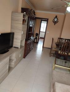 a living room with a flat screen tv on a counter at Piso en Grove in O Grove
