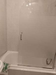 a shower with a glass door in a bathroom at Piso en Grove in O Grove +10 photos